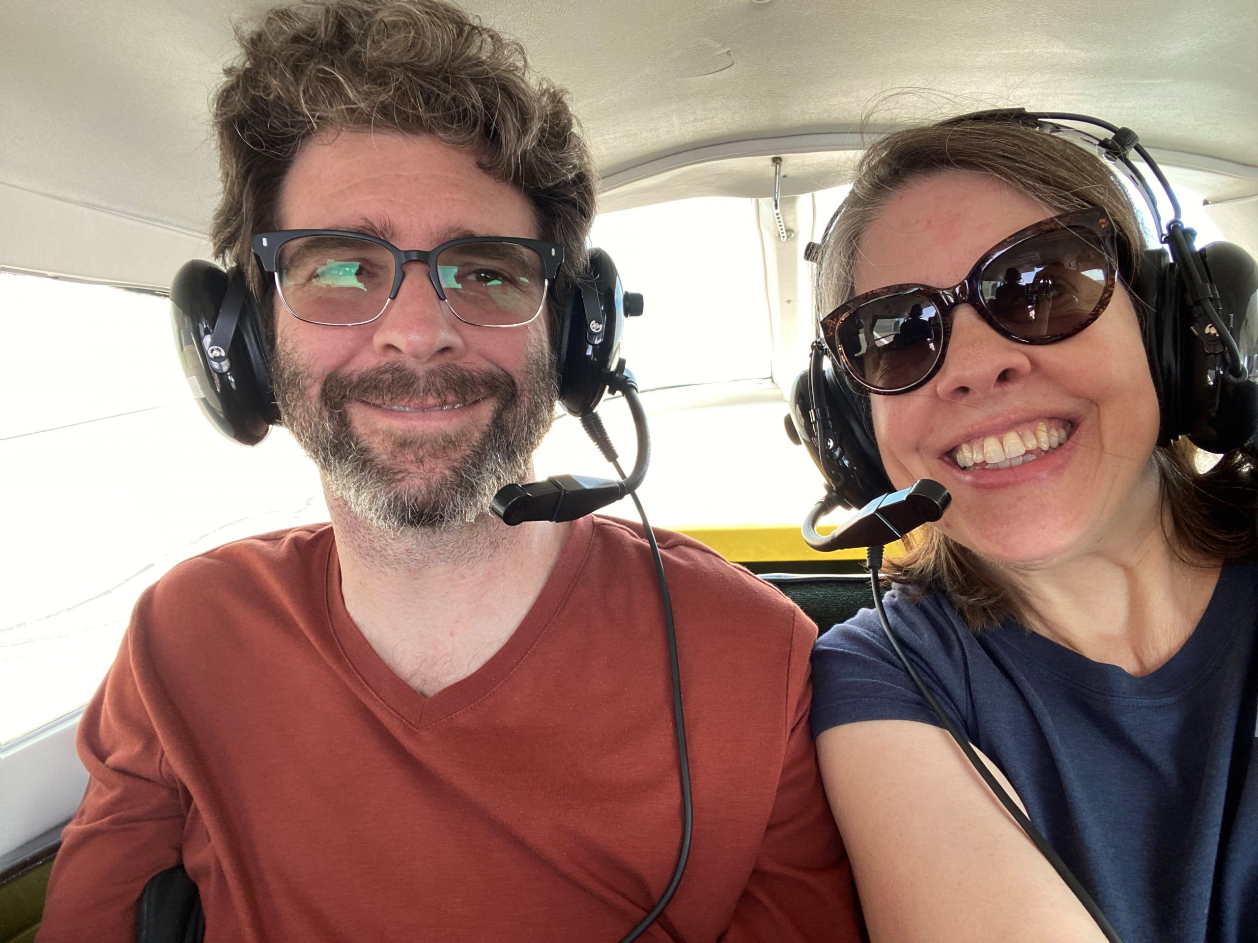 Sina and Drew in a plane, smiling.